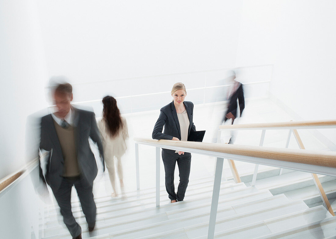 Business people rushing along stairs