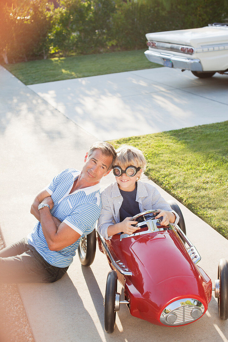 Father smiling with son in go cart