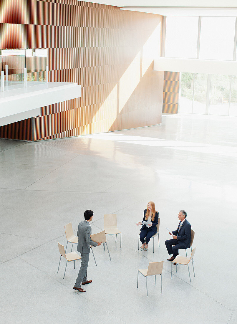 Businessman approaching co-workers