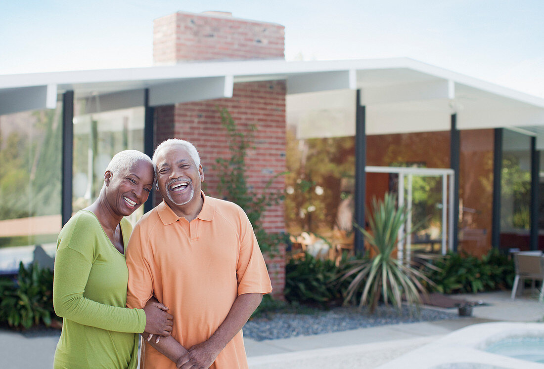 Older couple smiling in backyard