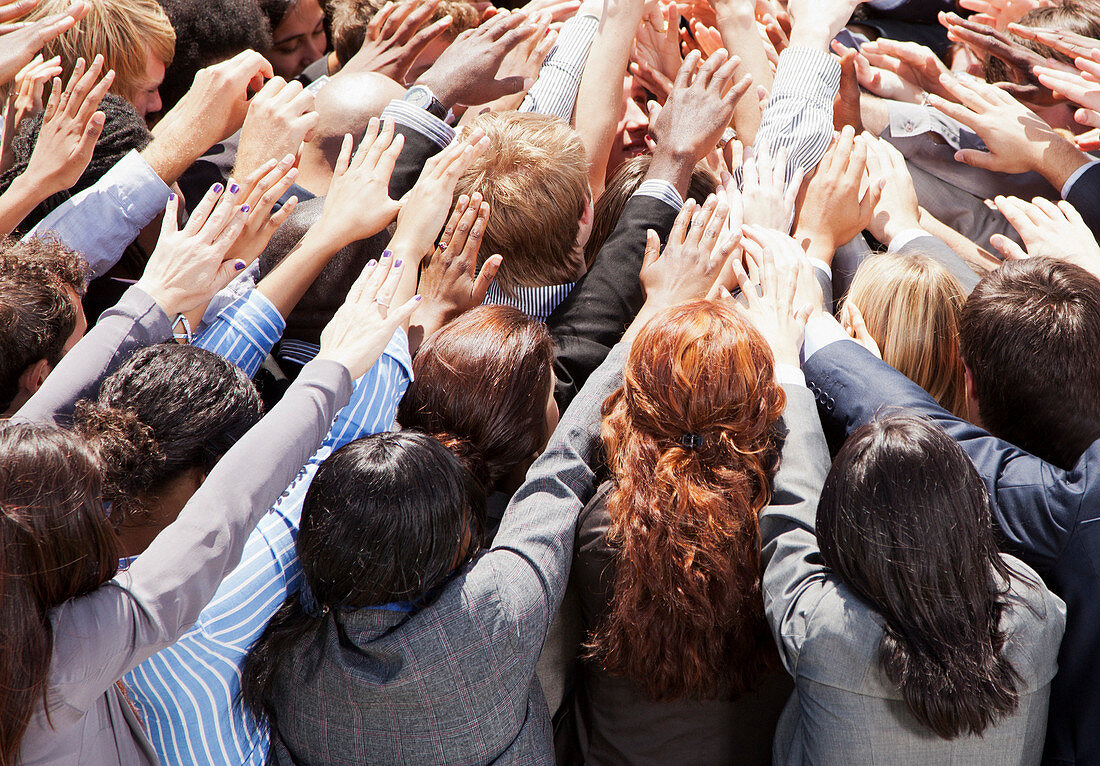 Crowd of business people reaching