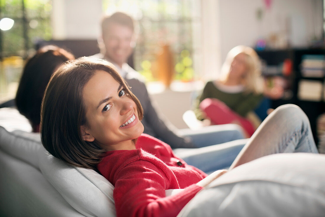 Smiling woman relaxing on sofa