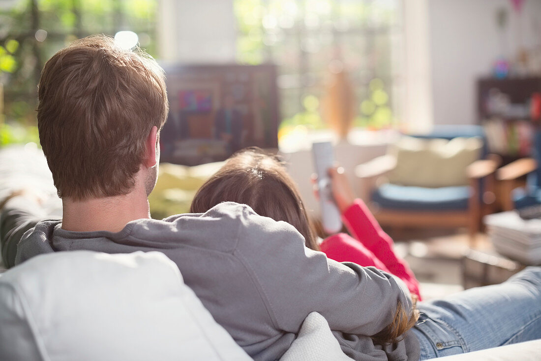 Couple relaxing on sofa together