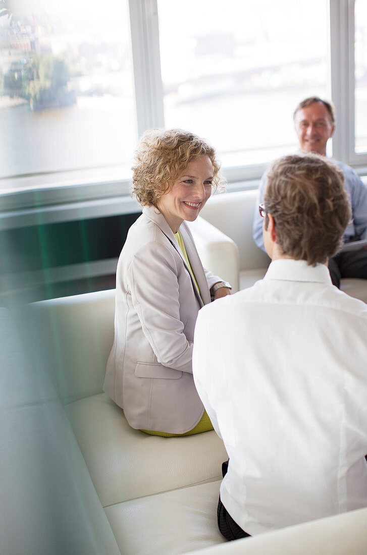 Business people talking in office lobby