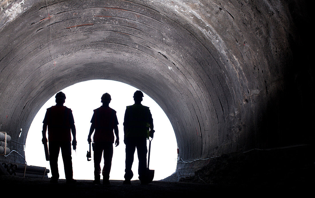 Silhouette of workers in tunnel