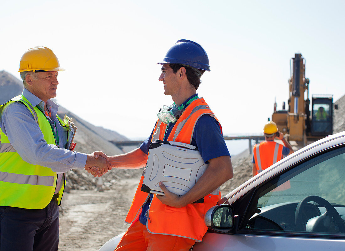 Worker and businessman shaking hands