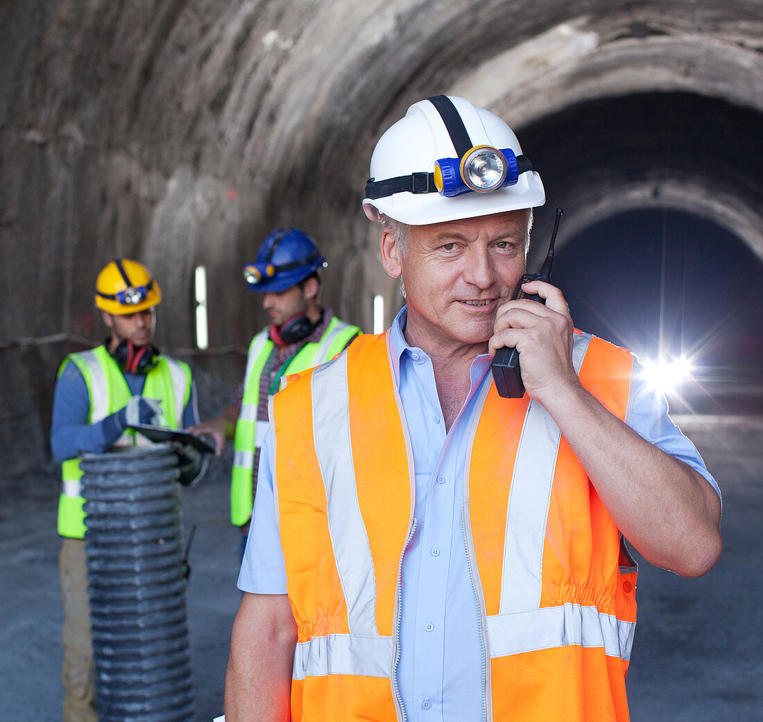 Businessman using walkie-talkie in tunnel