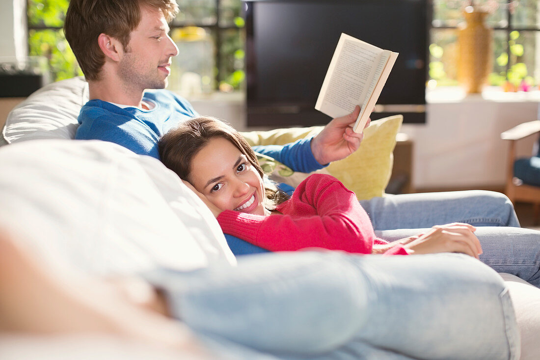 Couple relaxing together on sofa