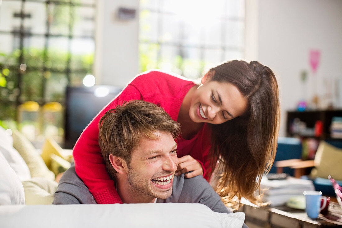 Couple playing together on sofa