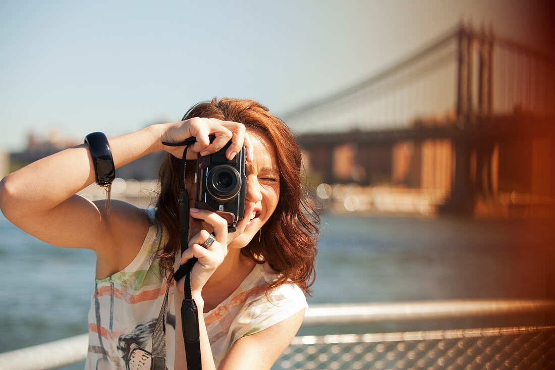 Woman taking picture by city cityscape