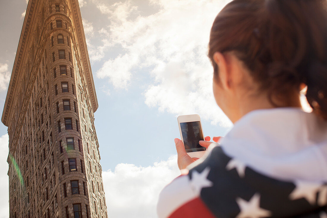 Woman taking picture of highrise