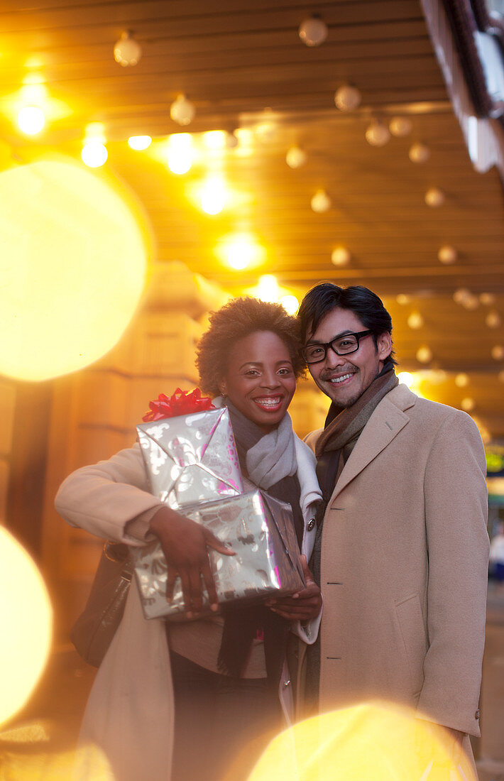 Couple carrying wrapped gifts