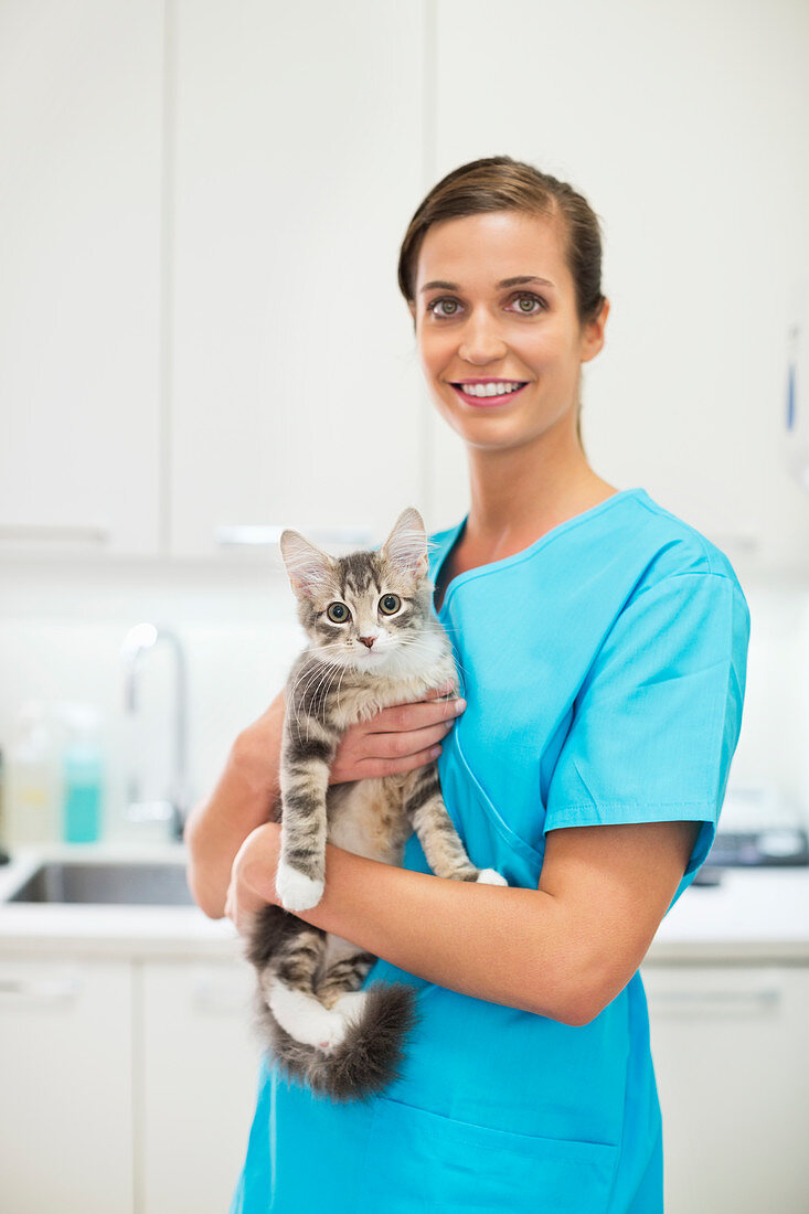 Smiling Veterinarian holding cat
