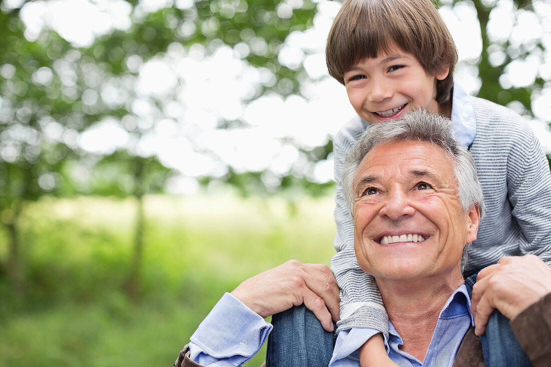 Man carrying grandson on his shoulders