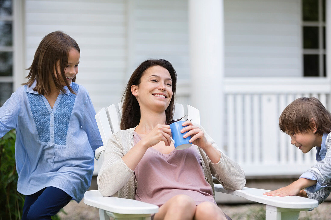 Mother and children relaxing outdoors