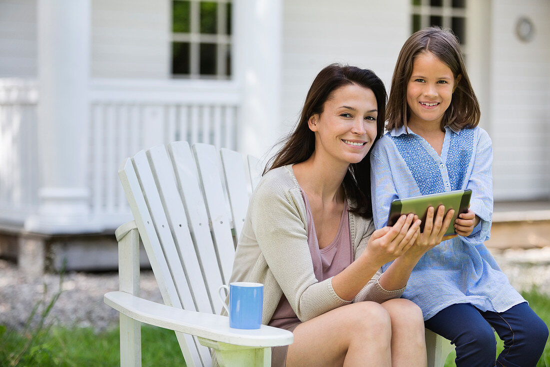 Mother and daughter using digital tablet