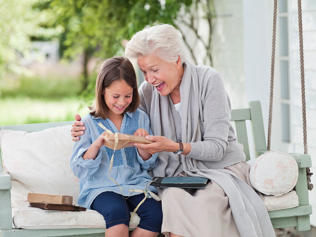 Woman giving granddaughter present