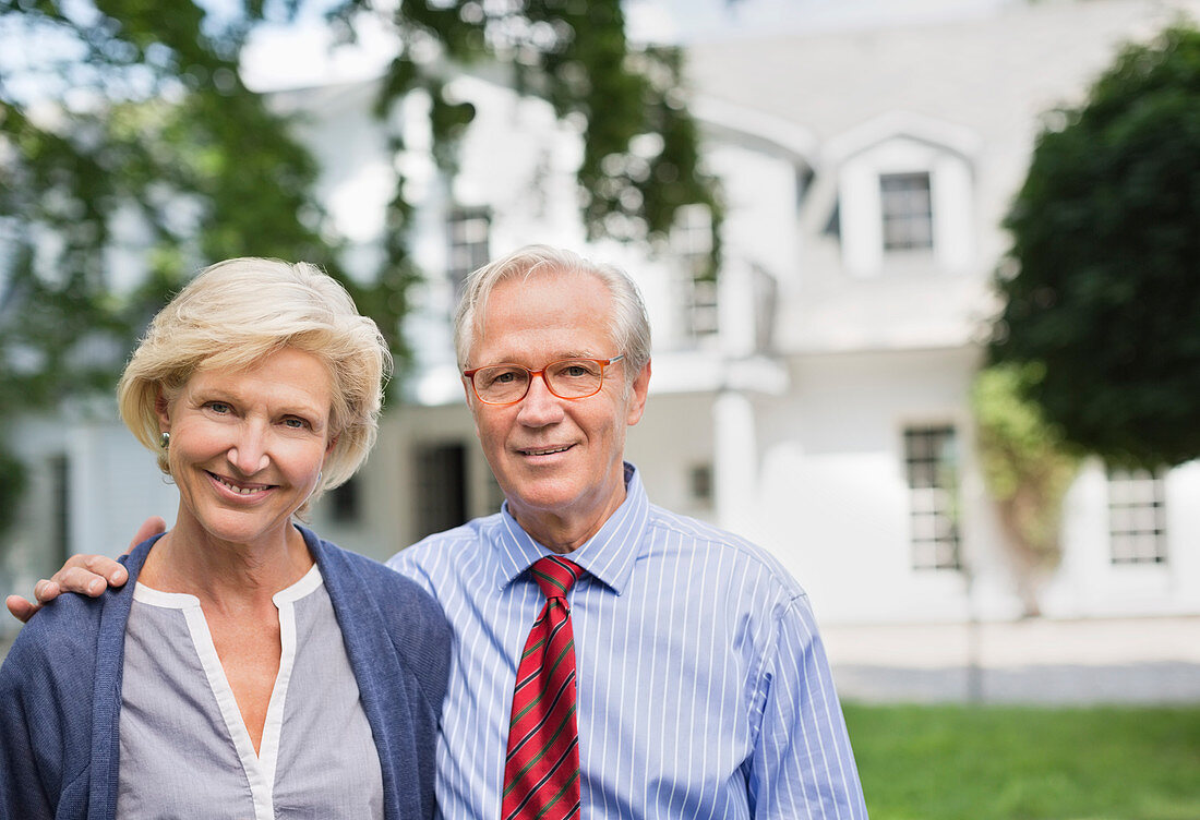 Couple smiling together outside house