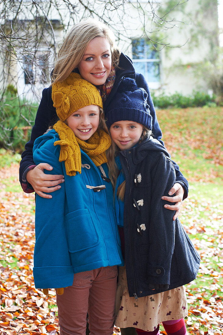 Mother and children smiling outdoors