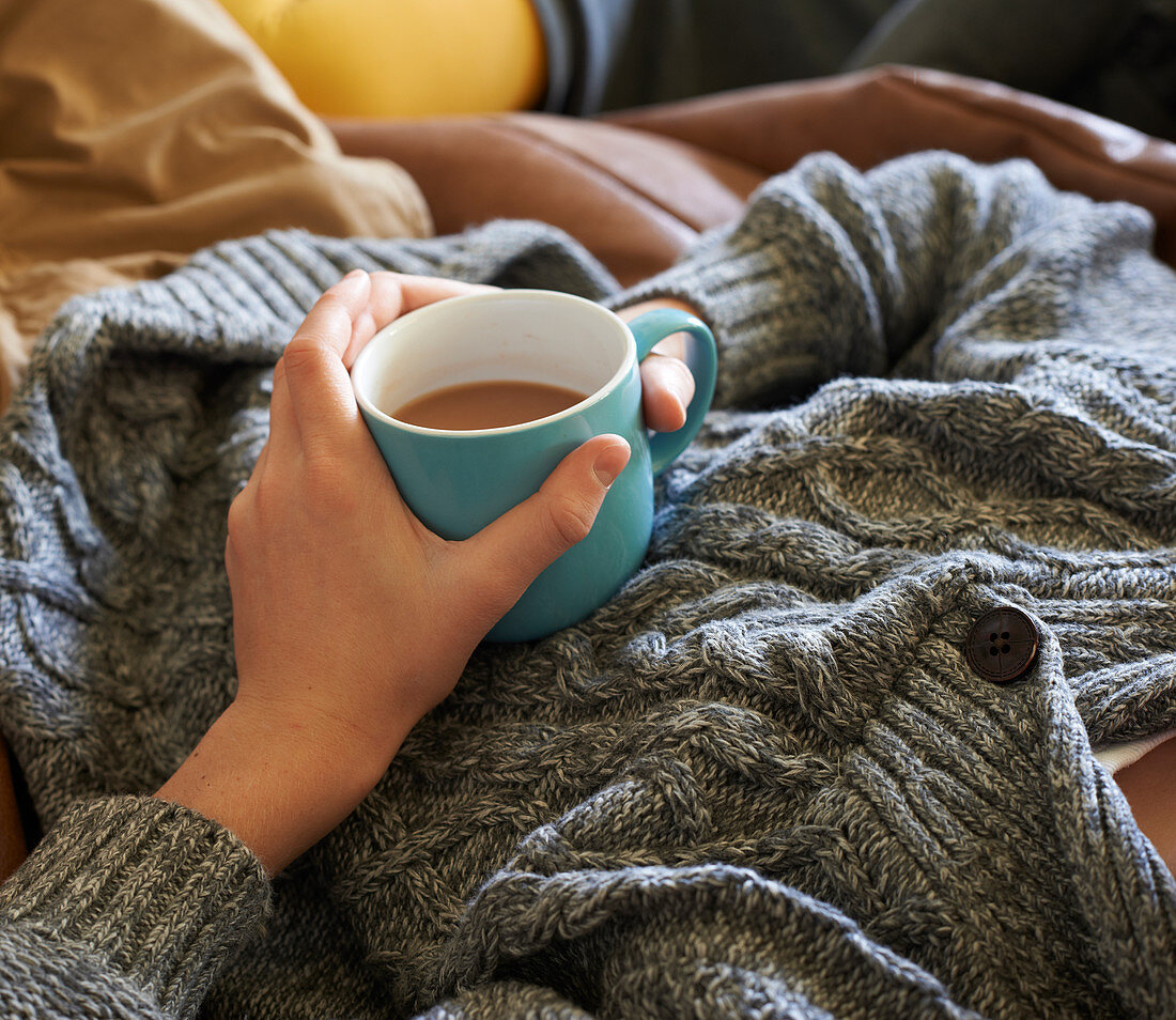 Close up of boy holding cup of tea