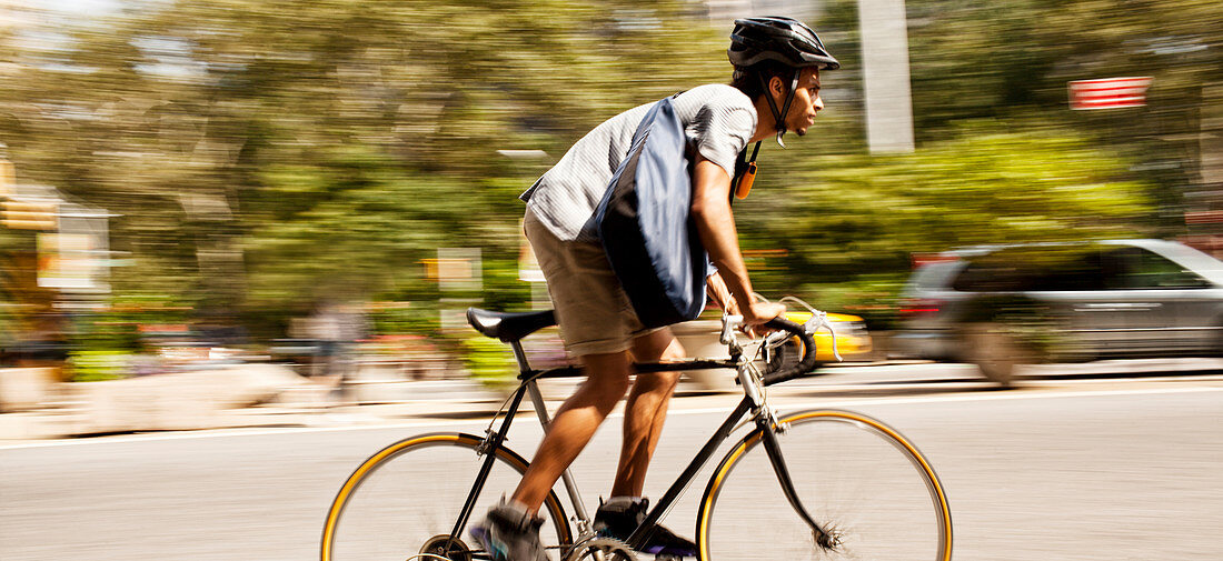 Man riding bicycle on city street