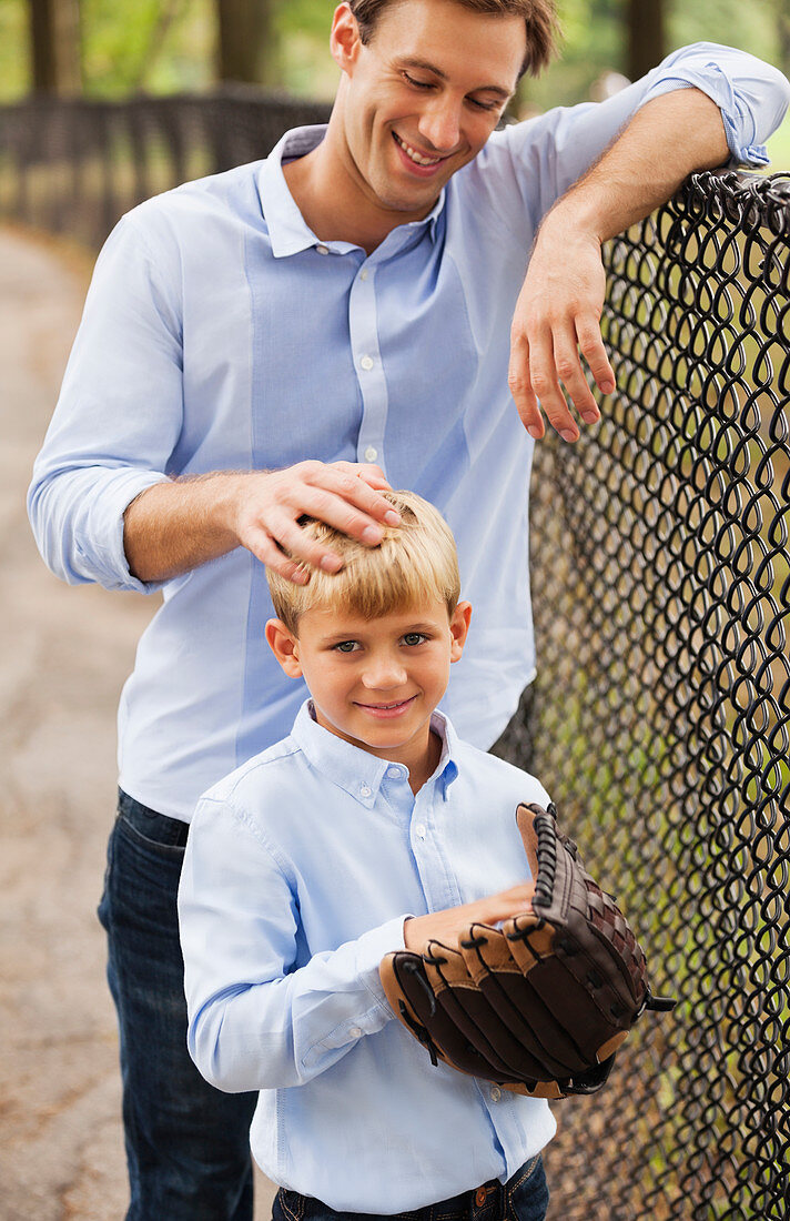 Father and son in baseball field