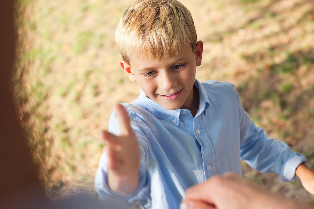 Father and son high fiving outdoors