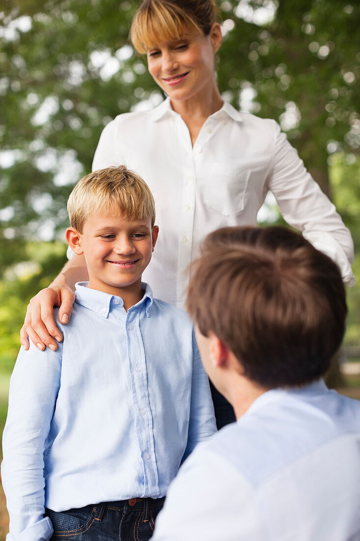 Mother, father and son talking in park