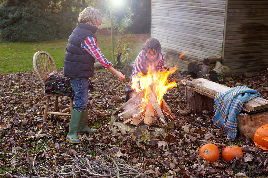 Children building bonfire outdoors