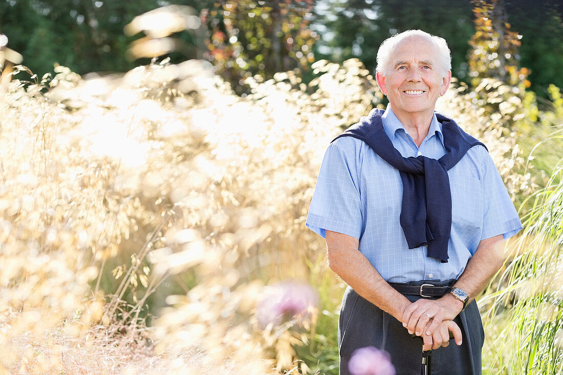 Smiling older man standing outdoors