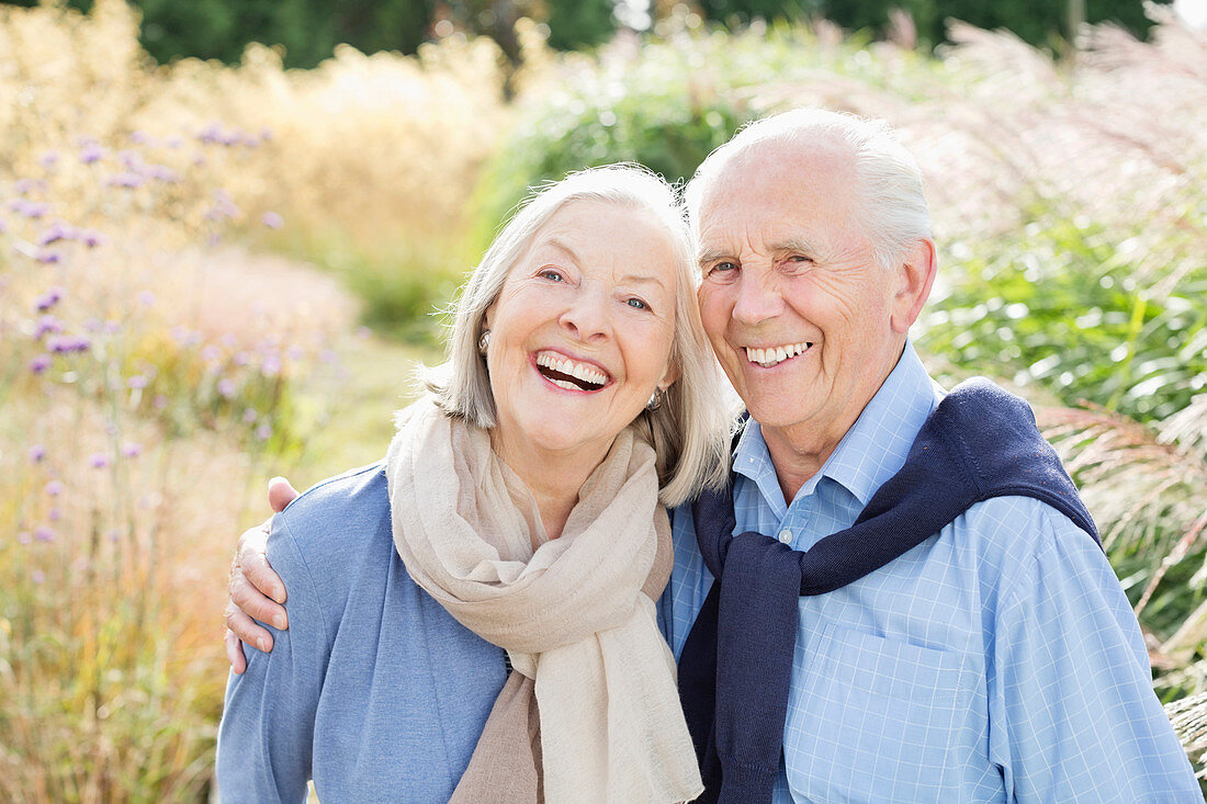 Older couple hugging outdoors