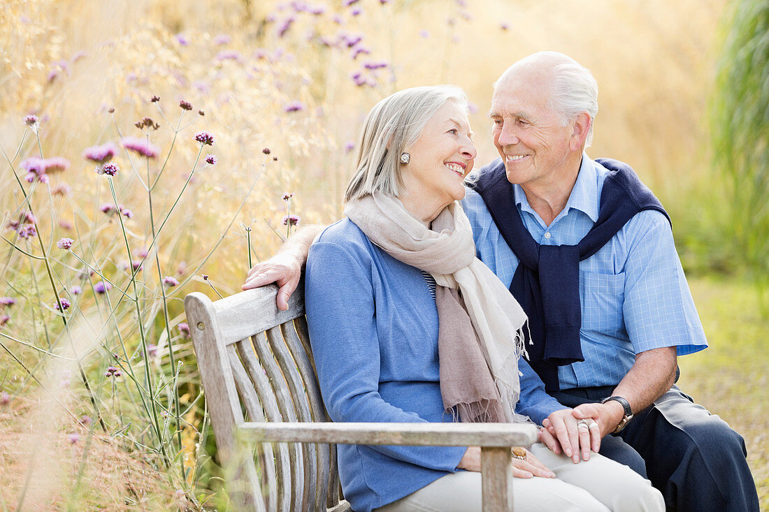 Older couple relaxing on park bench