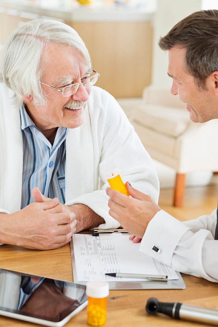 Doctor giving medication to older patient