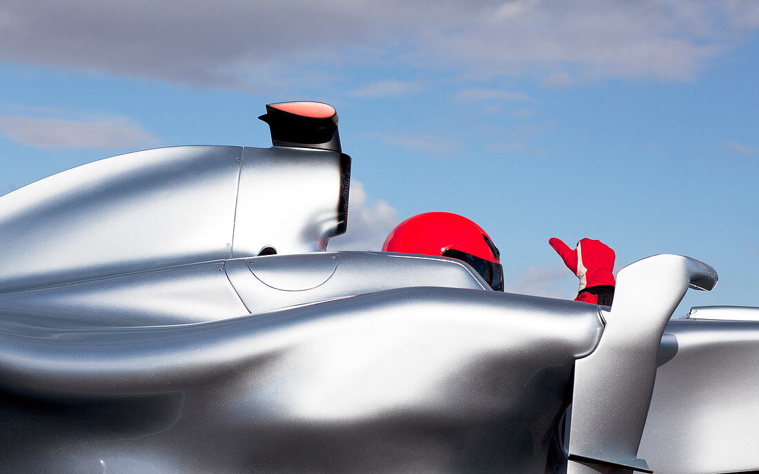 Racer giving thumbs up in car