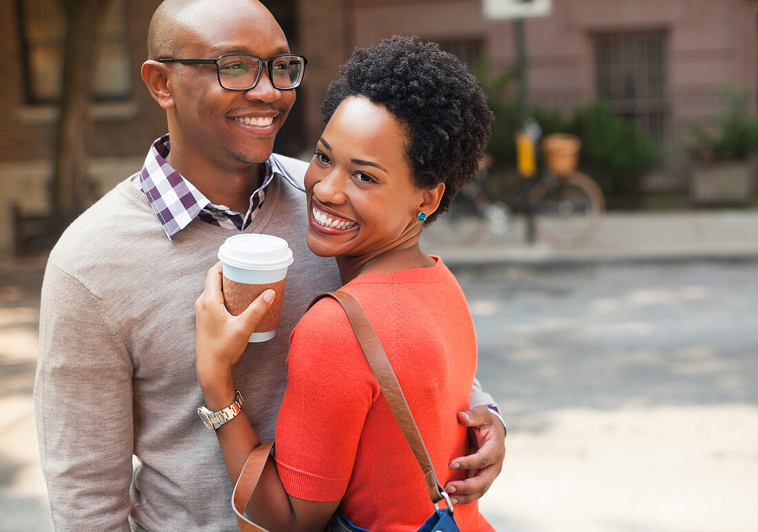 Couple hugging on city street