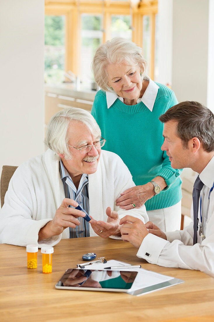 Doctor talking with patient and wife