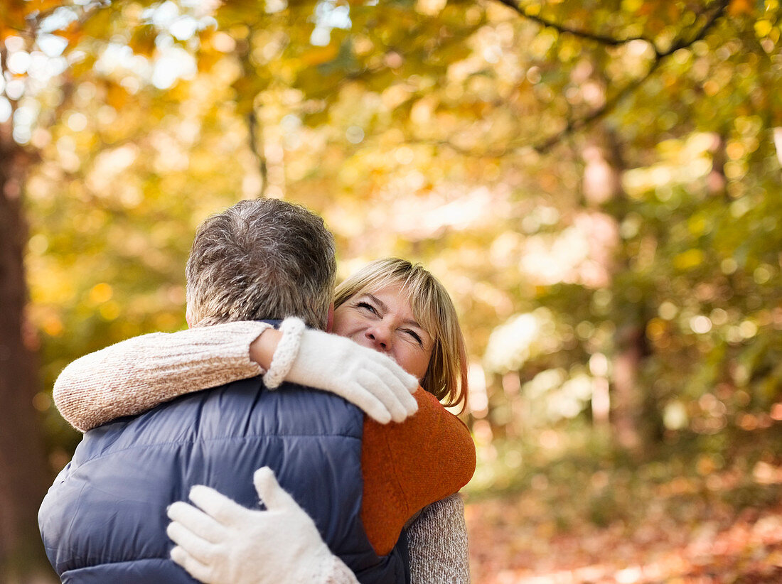 Older couple hugging in park