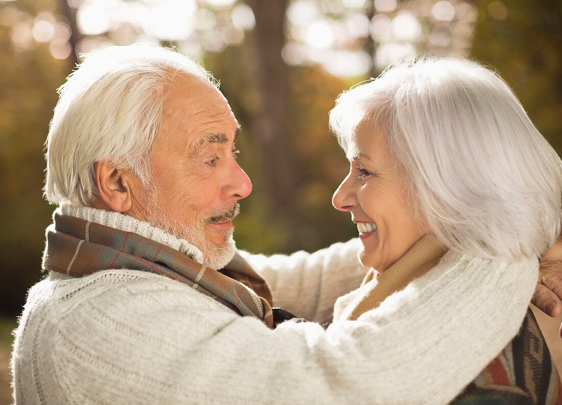 Older couple hugging outdoors