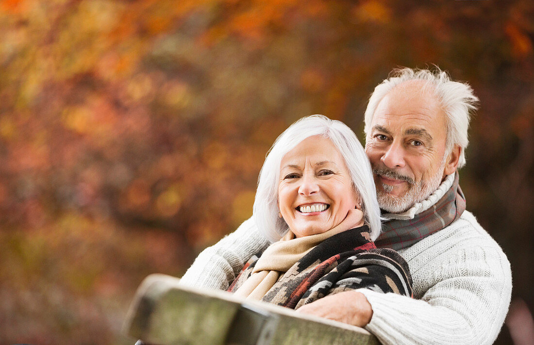 Older couple sitting on park bench