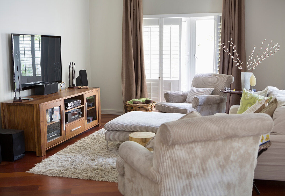 Television and armchairs in living room
