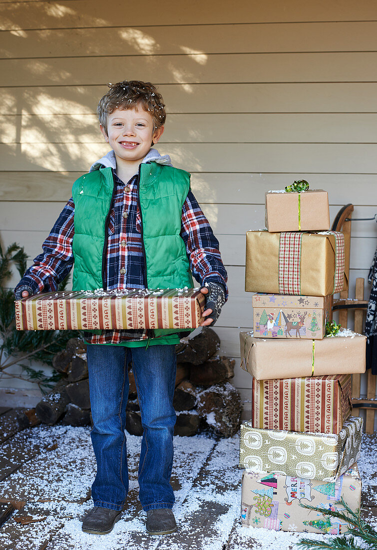 Boy holding Christmas gifts