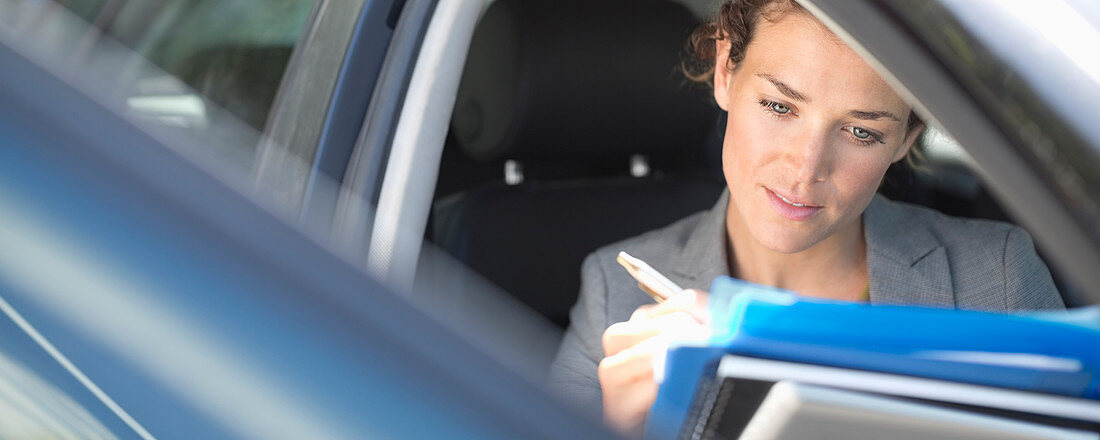 Businesswoman working in car