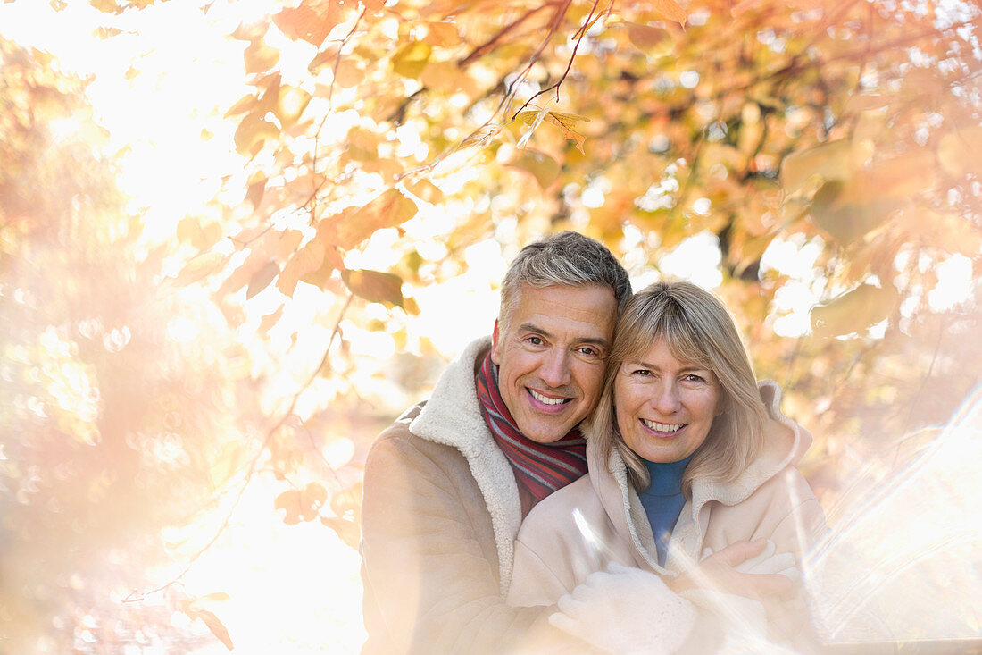 Older couple hugging in park