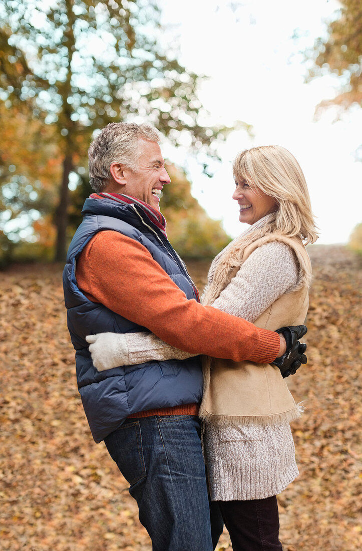 Older couple hugging in park