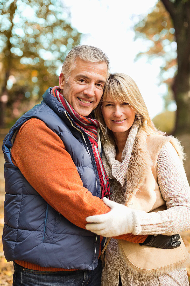 Older couple hugging in park