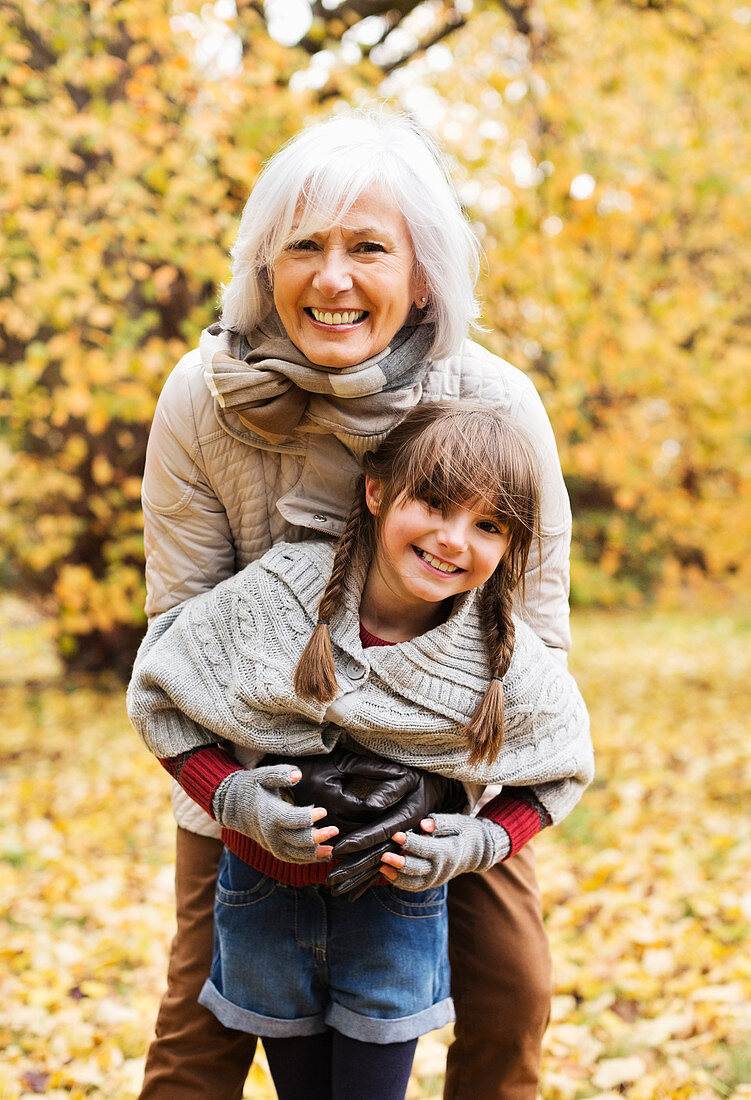 Woman and granddaughter hugging in park