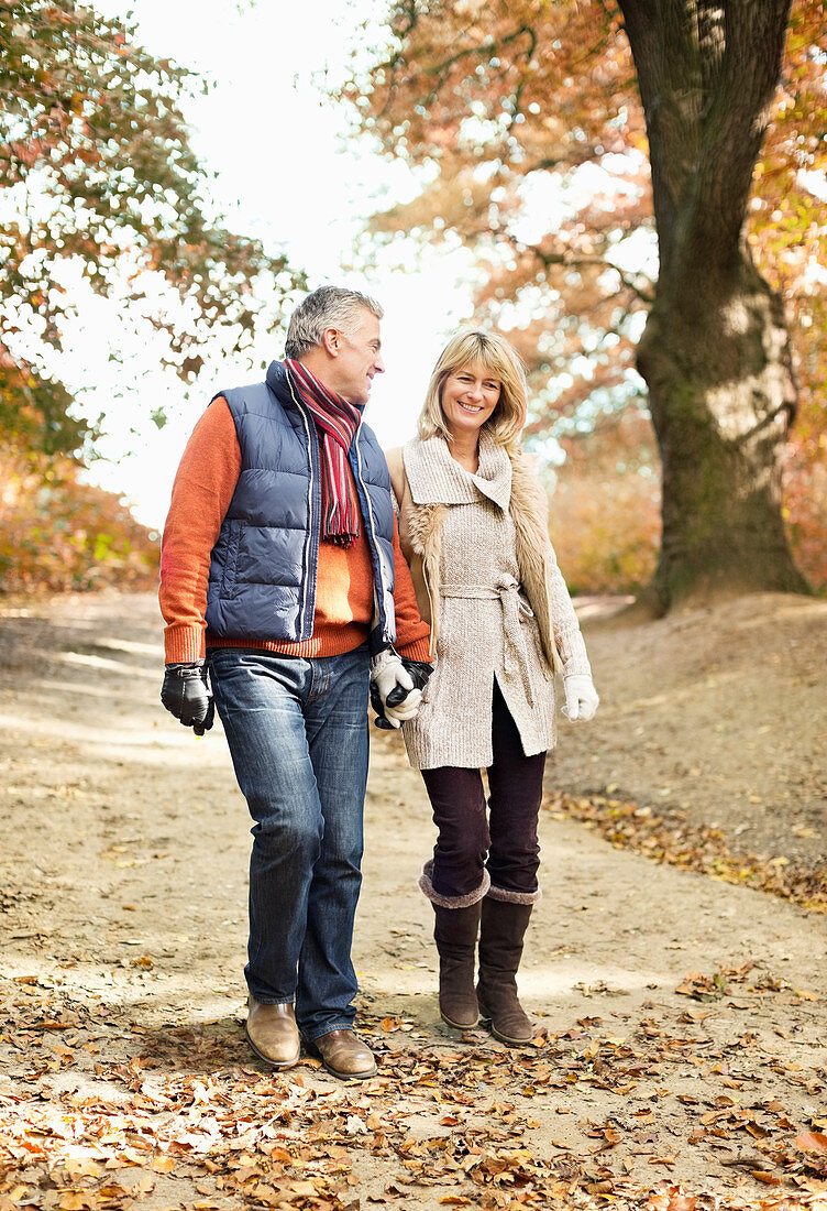 Older couple walking in park