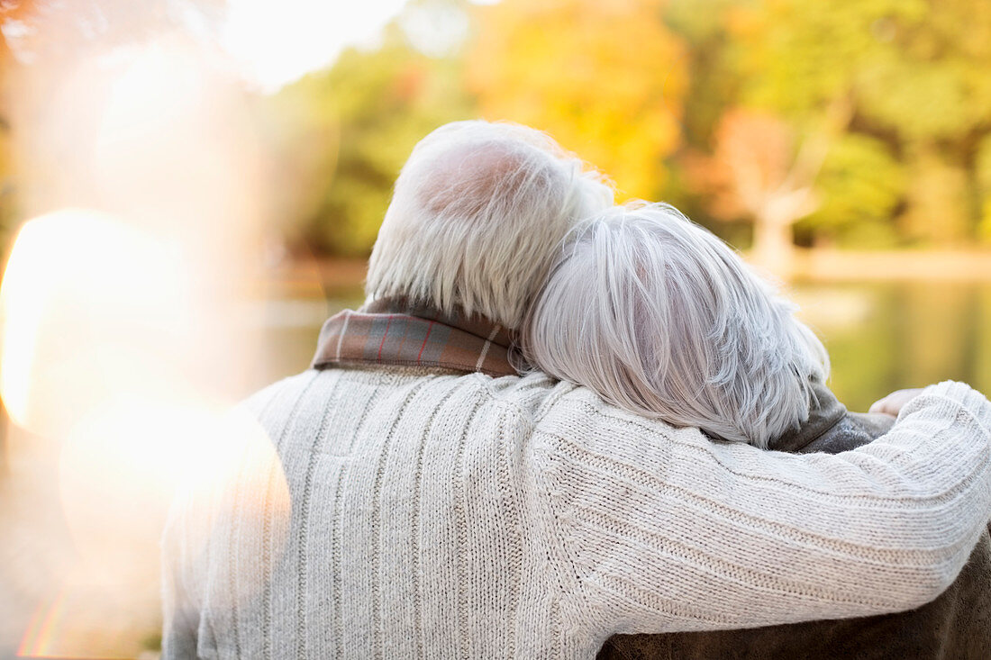 Older couple hugging in park