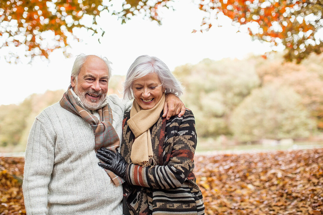 Older couple walking in park