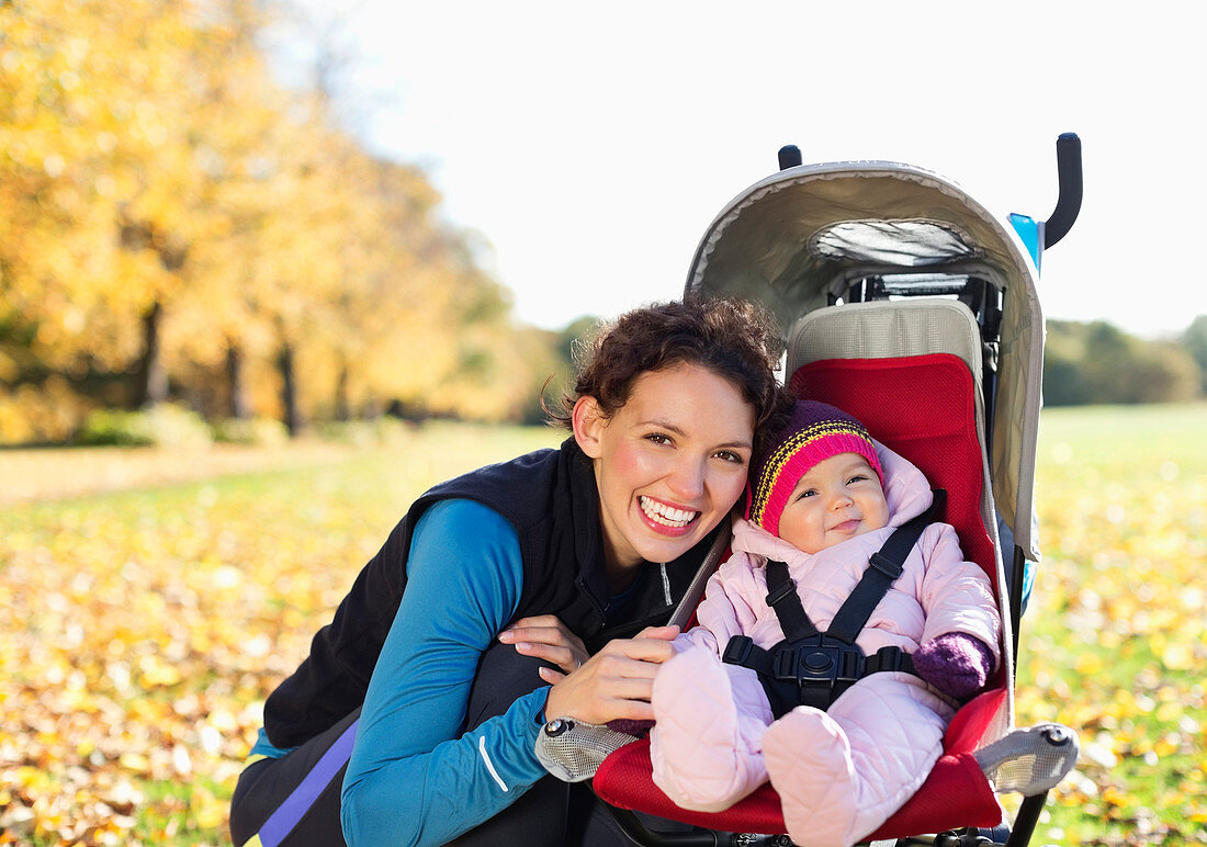 Woman smiling with baby in stroller